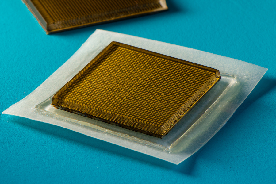 MIT engineers designed an adhesive patch that produces ultrasound images of the body. The stamp-sized device sticks to skin and can provide continuous ultrasound imaging of internal organs for 48 hours. @ Felice Frankel