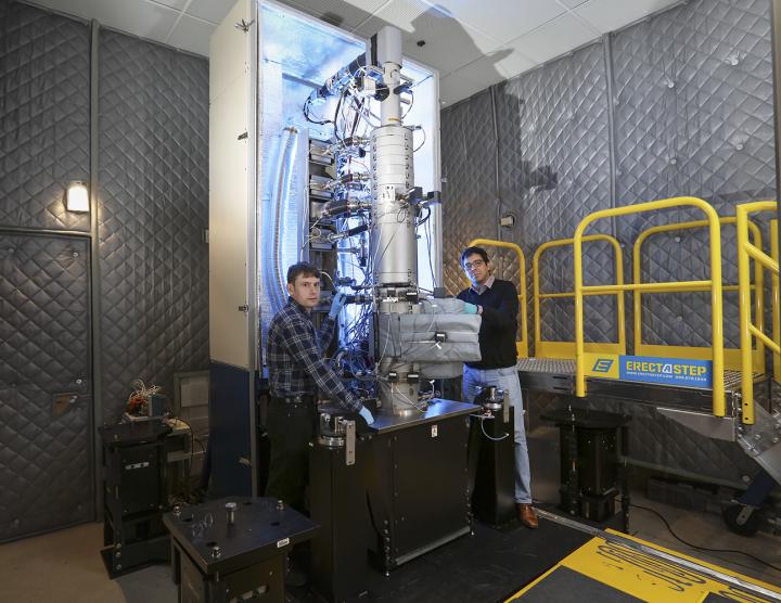 From left, Andrew Lupini and Juan Carlos Idrobo use ORNL's new monochromated, aberration-corrected scanning transmission electron microscope, a Nion HERMES to take the temperatures of materials at the nanoscale. @ Oak Ridge National Laboratory, US Dept. of Energy; photographer Jason Richards