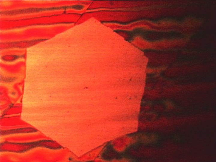 Visible to the naked eye: a wafer-thin graphene flake obtained via chemical vapor deposition. The red coloration of the copper substrate appears when the sample is heated in air. @ J. Kraus/ TUM