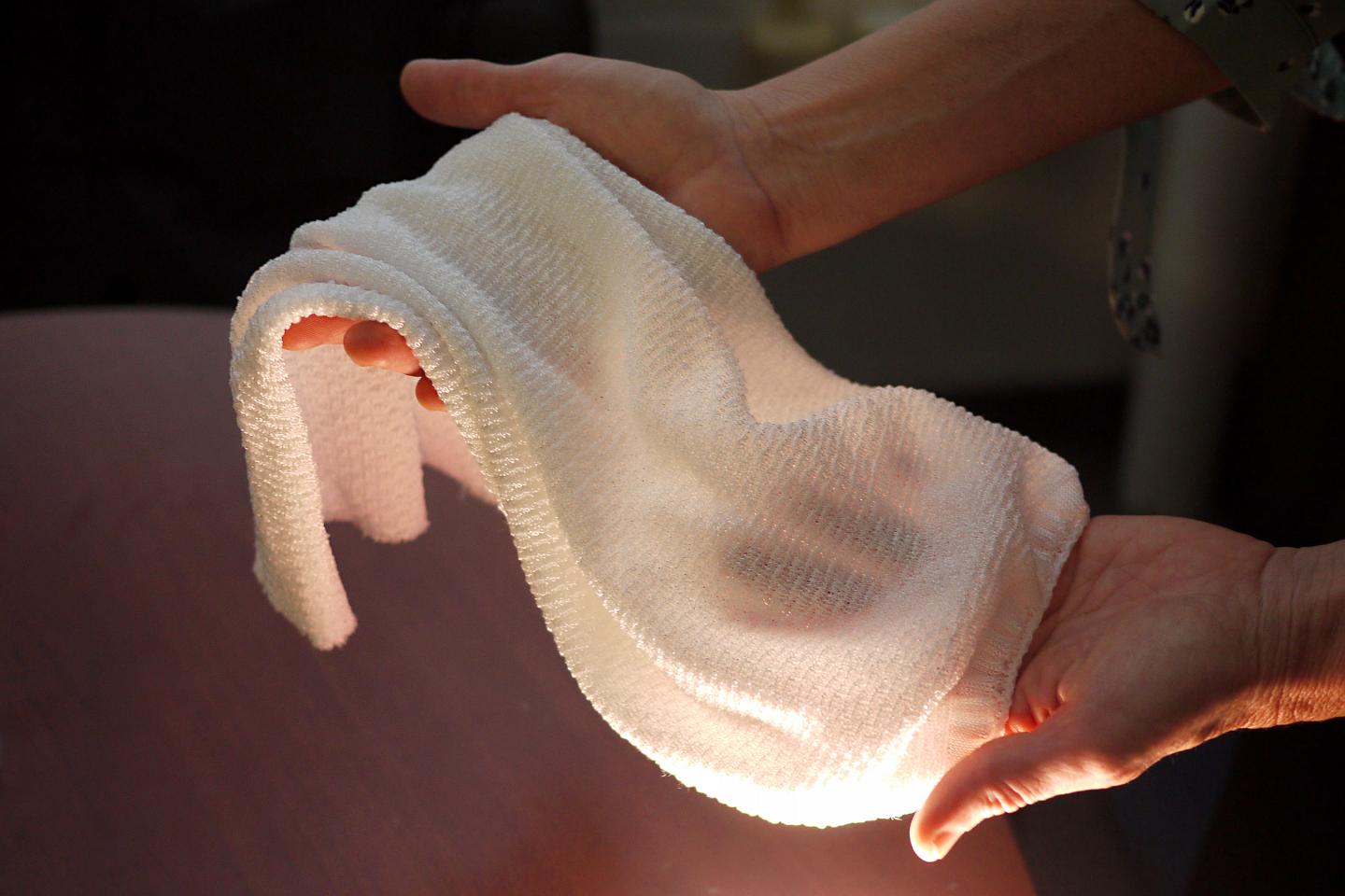 This new fabric being developed by University of Maryland scientists YuHuang Wang and Ouyang Min is the first textile to automatically change properties to trap or release heat depending on conditions. @ Faye Levine, University of Maryland